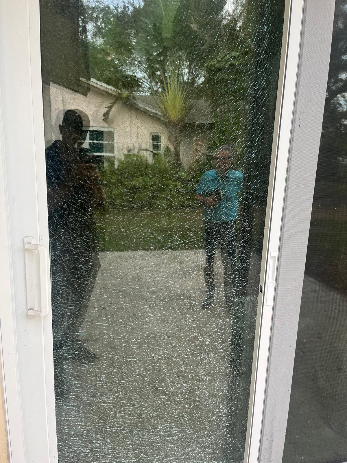 Shattered sliding glass door panel before glass replacement