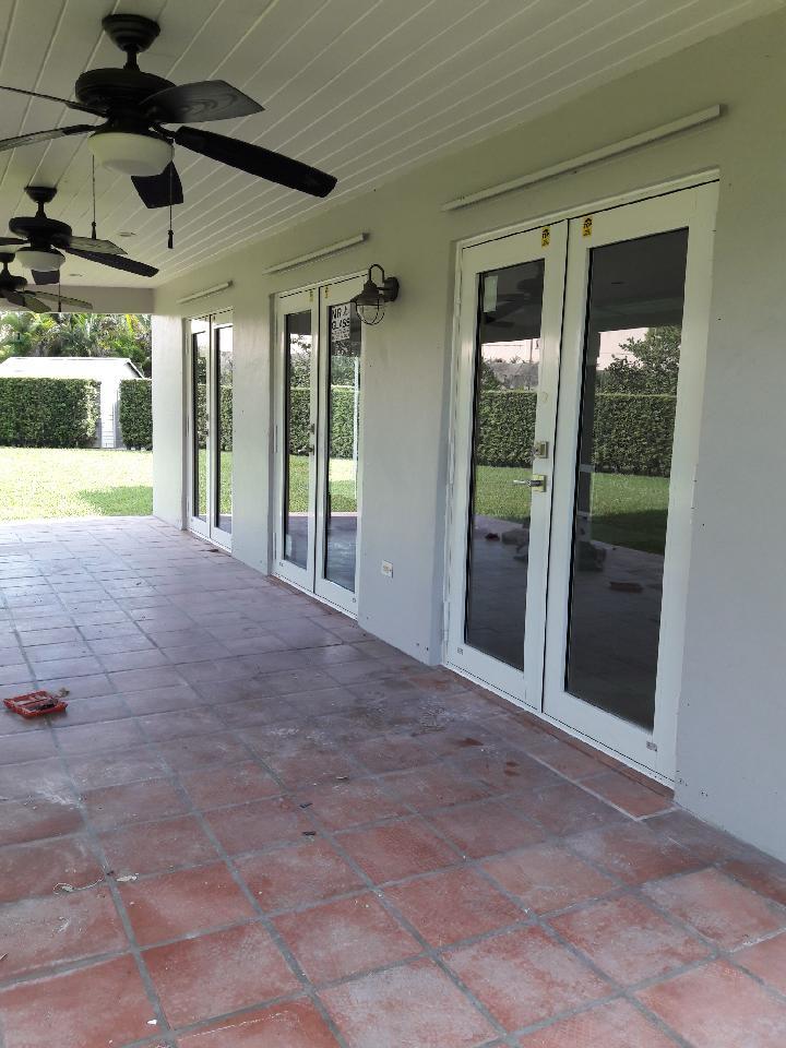 White impact French doors installed on a covered patio
