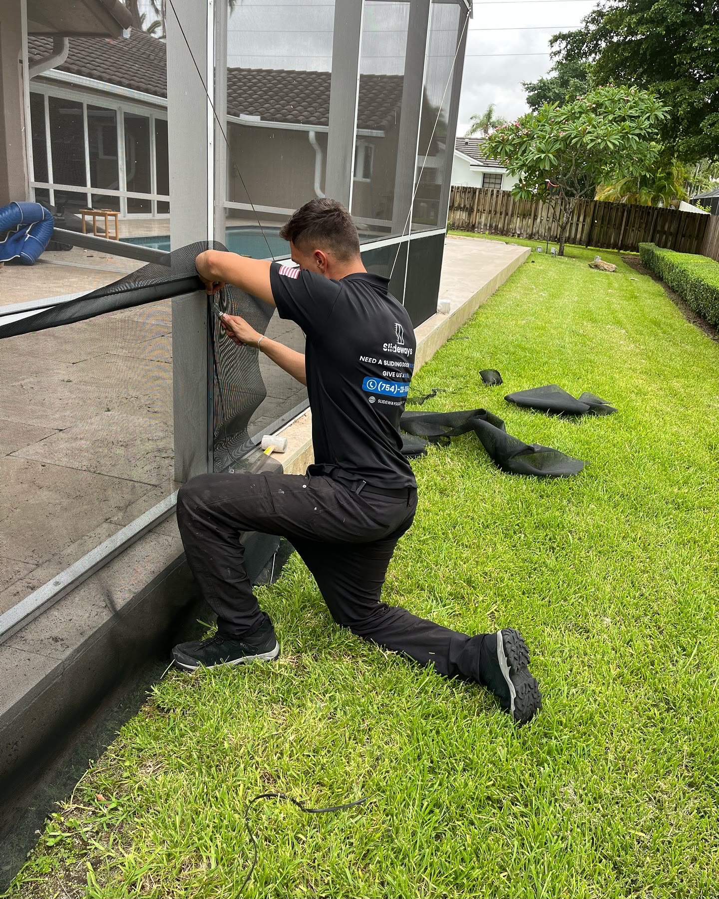 Slideways technician replacing mesh on a pool patio screen enclosure