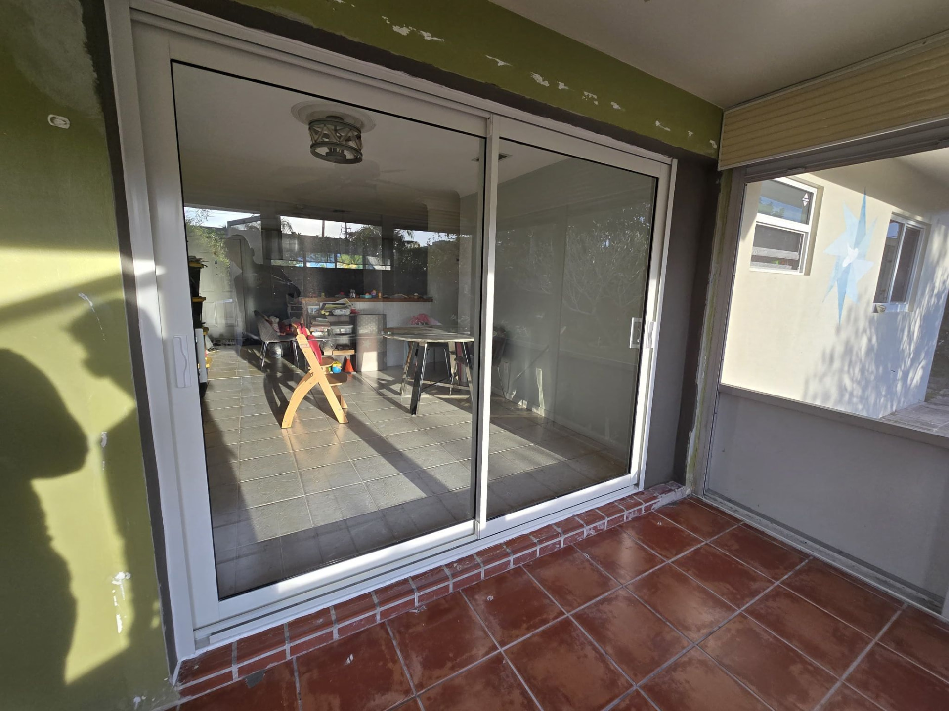 Repaired white-frame sliding glass door sliding smoothly again