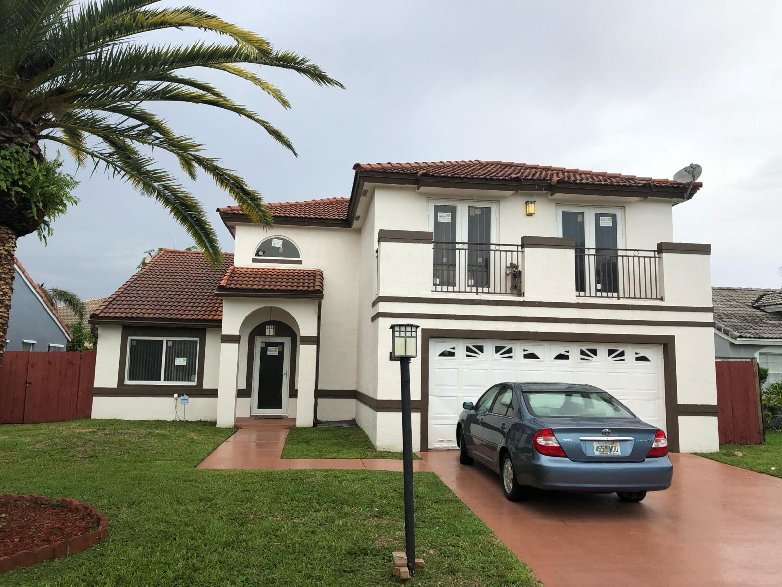 Completed impact window installation on a South Florida home with red tile roof